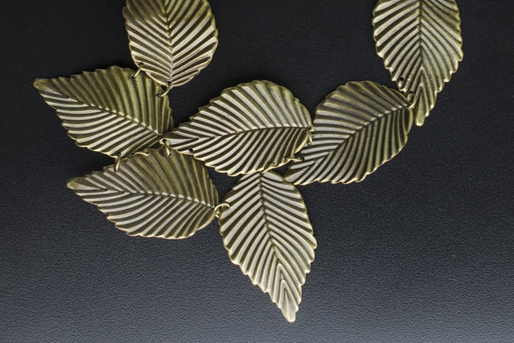 bronze macro necklace with leaves isolated on black